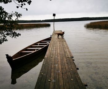 Pier on lake against sky