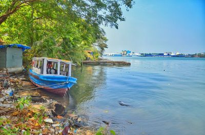 Boats moored on beach against sky