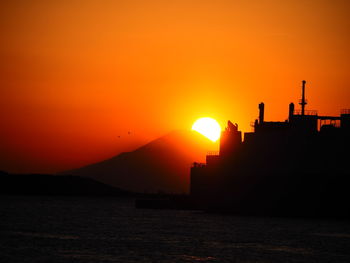 Scenic view of sea against romantic sky at sunset