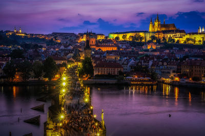 Sunset over the charles bridge and prague castle on the vltava river viewed from the old town  deck.