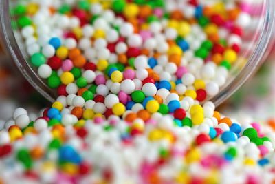 Close-up of colorful sprinkles by jar