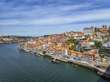 High angle view of river by townscape against sky