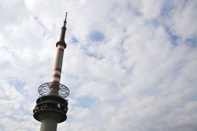 Low angle view of communications tower against sky