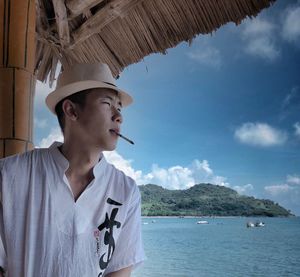 Man looking at sea against sky