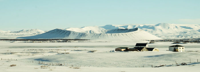 Scenic view of snowcapped mountains against clear blue sky
