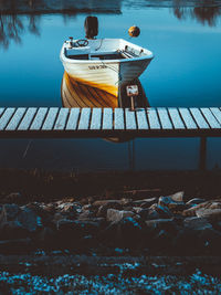 Boat by pier in lake