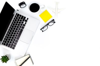 High angle view of laptop and coffee cup on table