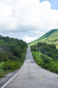 Empty road along landscape against sky