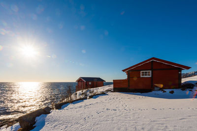 House on beach by sea against sky