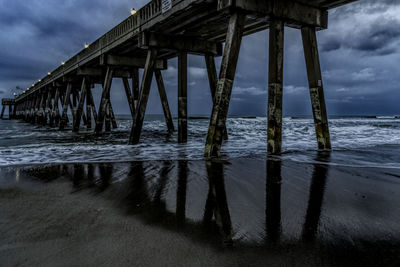 Wooden pier on sea against sky