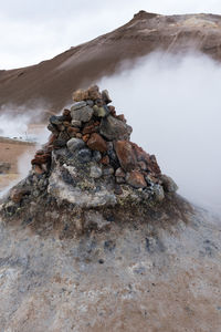 Scenic view of rock formation on land against sky