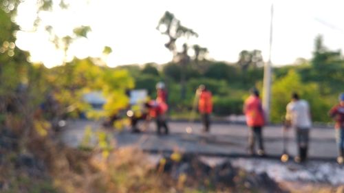 People walking on road against sky