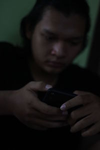 Close-up of man using mobile phone