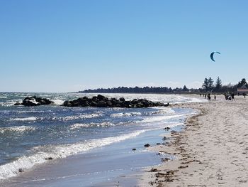 Scenic view of beach against clear blue sky