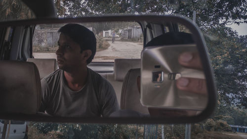 Portrait of man sitting in car