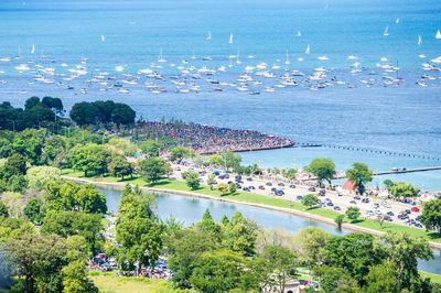 High angle view of sea and cityscape against sky