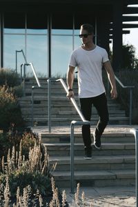 Full length of young man walking on staircase outdoors