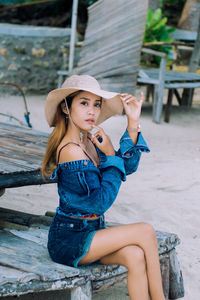 Portrait of young woman sitting outdoors