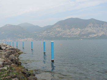 Scenic view of sea and mountains against sky