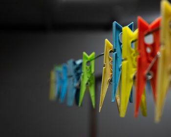 Close-up of multi colored clothespins hanging on clothesline