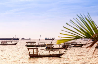 Deck chairs on beach against sky