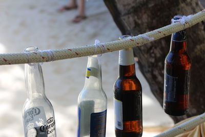 High angle view of beer bottles hanging from rope