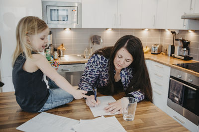 Women with daughter in kitchen