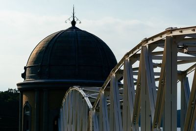 Low angle view of cross against sky