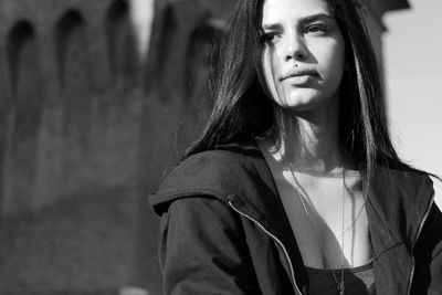 Young woman looking away in city