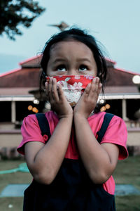 Portrait of a smiling girl standing outdoors