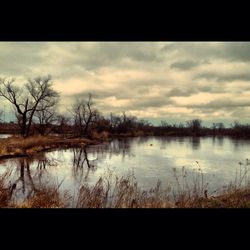 Scenic view of lake against cloudy sky