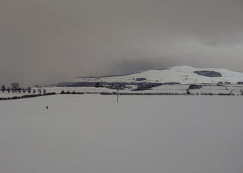 Scenic view of frozen lake against sky during winter