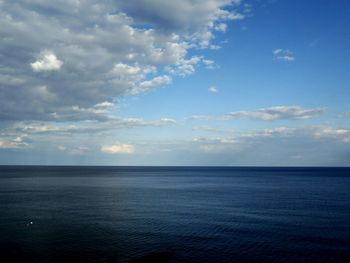 View of calm sea against cloudy sky