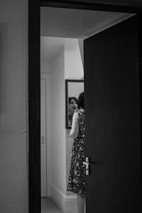 Woman standing by door