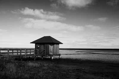 House at beach against sky