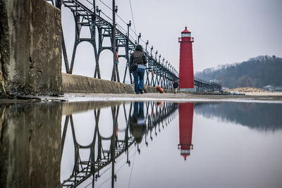 Full length rear view of person walking on pier