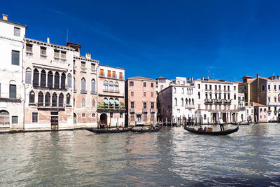 Boats in canal along buildings