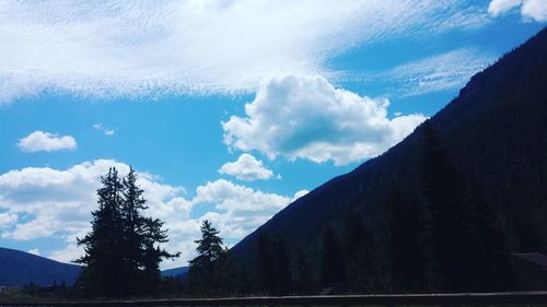 Scenic view of mountains against cloudy sky