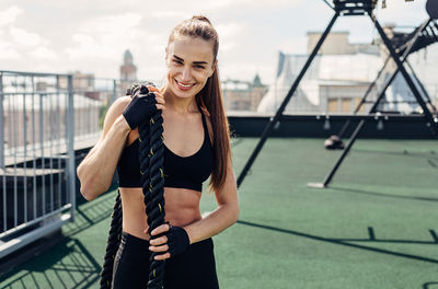 Portrait of a smiling young woman standing outdoors