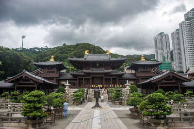 Buildings against cloudy sky