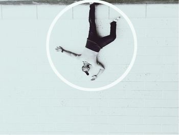 Upside down image of man standing against wall