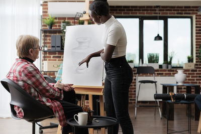 Woman teaching student at workshop