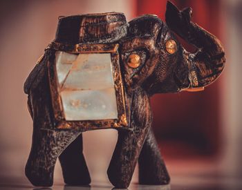 Close-up of elephant figurine on table