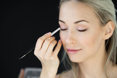 Portrait of woman holding hands