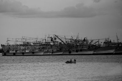 View of fishing boats in sea against sky