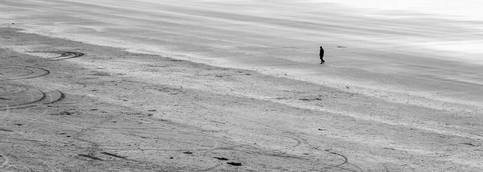 Man walking on barren field