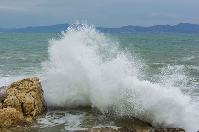 Sea waves splashing on rocks
