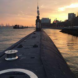 View of city at waterfront during sunset