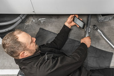 High angle view of man using mobile phone