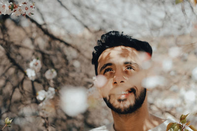 Portrait of young man against blurred background